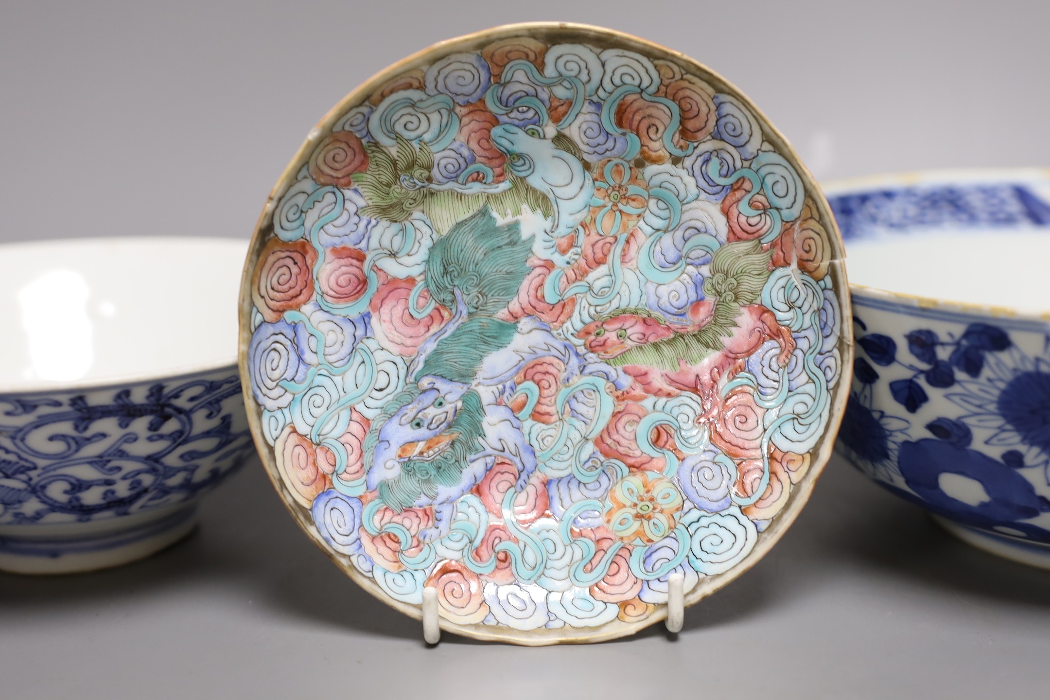 A Chinese blue and white dragon bowl, another blue and white bowl and a saucer, 19th century, largest 20.5cm